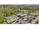 Aerial view of a community featuring tennis courts, a lake, and dense trees, combining active recreation with natural beauty at 5103 San Martino Dr, Wesley Chapel, FL 33543