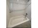 Bathroom featuring bathtub, white tiles, and shower at 5111 28Th N Ave, St Petersburg, FL 33710