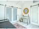 Bedroom showcases daybed, sliding doors, desk area with a round decorative mirror at 5111 28Th N Ave, St Petersburg, FL 33710