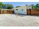 Light blue home featuring a wood fence and a low-maintenance gravel yard at 5111 28Th N Ave, St Petersburg, FL 33710