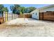 Gravel driveway next to a light blue house with a modern wood fence and mature trees at 5111 28Th N Ave, St Petersburg, FL 33710