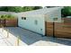 Side exterior featuring modern design elements, a well-maintained yard, and a privacy fence at 5111 28Th N Ave, St Petersburg, FL 33710