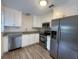 Modern kitchen featuring stainless steel appliances, white cabinetry, and granite countertops at 5111 28Th N Ave, St Petersburg, FL 33710