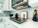 Modern kitchen features white cabinets, speckled countertops, and stainless steel microwave at 5111 28Th N Ave, St Petersburg, FL 33710