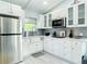 Well-equipped kitchen with stainless steel appliances and white cabinetry at 5111 28Th N Ave, St Petersburg, FL 33710