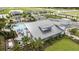Aerial view of community pool and recreation center surrounded by green spaces and homes at 5120 125Th E Ave, Parrish, FL 34219