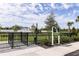 Fenced dog park with secure entry, grassy area, and mature trees, offering a safe space for pets to socialize at 5120 125Th E Ave, Parrish, FL 34219