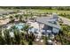 Aerial view of resort-style pool, lounge area, and outdoor amenities surrounded by green spaces at 5120 125Th E Ave, Parrish, FL 34219