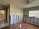 Bedroom with ceiling fan and tile flooring, prepped for renovation at 5813 Oxford Dr, Tampa, FL 33615