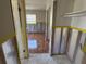 Bedroom featuring tile floors, window and closet area, prepped for renovation at 5813 Oxford Dr, Tampa, FL 33615