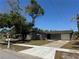 Charming one-story home featuring a well-maintained lawn and a paved driveway at 5813 Oxford Dr, Tampa, FL 33615