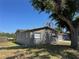 Exterior home view with a tree in the front yard at 5813 Oxford Dr, Tampa, FL 33615