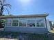 Back of house featuring an enclosed porch with many windows at 5813 Oxford Dr, Tampa, FL 33615