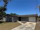 Charming one-story home featuring a well-maintained lawn and a paved driveway at 5813 Oxford Dr, Tampa, FL 33615
