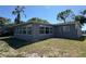 Rear view of the home with a door entry and several windows at 5813 Oxford Dr, Tampa, FL 33615