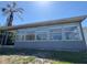 Back of house featuring an enclosed porch with many windows at 5813 Oxford Dr, Tampa, FL 33615