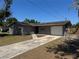 Charming single-story home featuring a one-car garage, gray brick exterior, and a well-manicured lawn at 5813 Oxford Dr, Tampa, FL 33615