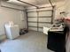 Spacious garage needing TLC with white walls and some appliances at 5813 Oxford Dr, Tampa, FL 33615