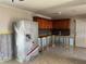 Kitchen featuring tiled floors, wooden cabinets and countertop, and a modern fridge at 5813 Oxford Dr, Tampa, FL 33615