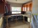 Close-up of kitchen area featuring counter, cabinets, window, faucet, and backsplash at 5813 Oxford Dr, Tampa, FL 33615