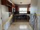 Kitchen area showcasing the countertop, wooden cabinets, backsplash, and tiled floors at 5813 Oxford Dr, Tampa, FL 33615