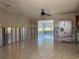 Bright living room featuring tile floors and views into the bright sunroom and open kitchen area at 5813 Oxford Dr, Tampa, FL 33615