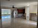 Spacious living room with tile flooring, ceiling fan, and view into the windowed sunroom at 5813 Oxford Dr, Tampa, FL 33615