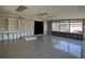 Large sun room featuring built-in shelving, tile floors and outdoor views at 5813 Oxford Dr, Tampa, FL 33615