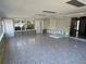 Large sun room featuring built-in shelving, tile floors and outdoor views at 5813 Oxford Dr, Tampa, FL 33615