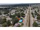 An aerial perspective shows the home's location within a lush, green area with a canal and cityscape in the distance at 6715 16Th N St, St Petersburg, FL 33702