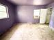 Bedroom with painted lavender walls featuring two windows, an air conditioner, and a closet at 6715 16Th N St, St Petersburg, FL 33702