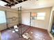 Damaged bedroom featuring a canopy bed frame, wood floors, and a window with an air conditioning unit at 6715 16Th N St, St Petersburg, FL 33702