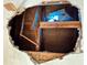 Close-up of a ceiling with a large hole revealing exposed beams and structural damage at 6715 16Th N St, St Petersburg, FL 33702