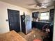 Dated kitchen featuring black cabinets, stainless steel fridge, and drop ceiling at 6715 16Th N St, St Petersburg, FL 33702
