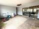 Spacious living room featuring unfinished ceiling, bare floors, and sliding doors at 6715 16Th N St, St Petersburg, FL 33702