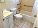 Functional bathroom with a white vanity, toilet, and bathtub with grab bars at 7425 W Maryland W Ave, Hudson, FL 34667