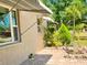 Charming home exterior featuring a paved patio and lush landscaping at 7425 W Maryland W Ave, Hudson, FL 34667