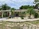 Well-maintained single-story home with decorative rock landscaping and mature palm trees in the front yard at 7425 W Maryland W Ave, Hudson, FL 34667