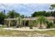 Charming single-story home featuring lush landscaping, rock garden, and a convenient carport at 7425 W Maryland W Ave, Hudson, FL 34667