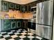 Kitchen featuring stainless steel appliances, dark wood cabinetry, and black and white checkered floors at 7425 W Maryland W Ave, Hudson, FL 34667