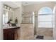 Bright bathroom featuring a glass-enclosed shower and modern vanity with natural light at 7533 Dunbridge Dr, Odessa, FL 33556