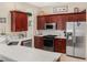 Stylish kitchen with stainless steel appliances, quartz countertops, and dark wood cabinetry at 7533 Dunbridge Dr, Odessa, FL 33556