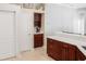 Modern kitchen area featuring custom dark wood cabinets and quartz countertops at 7533 Dunbridge Dr, Odessa, FL 33556