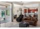 Open-concept living space with comfortable seating and views of the kitchen and outdoor patio at 7533 Dunbridge Dr, Odessa, FL 33556
