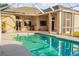 Inviting screened-in pool with an expansive patio area, perfect for outdoor relaxation and entertainment at 7533 Dunbridge Dr, Odessa, FL 33556