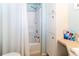 Bathroom featuring a shower with a curtain, a shower caddy and a built-in cabinet at 7714 Sailwinds Pass, Port Richey, FL 34668