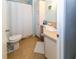 Bathroom with a toilet, a shower with a curtain, and cabinet space at 7714 Sailwinds Pass, Port Richey, FL 34668