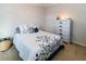 Comfortable bedroom with a queen bed, soft lighting, and a decorative dresser at 7714 Sailwinds Pass, Port Richey, FL 34668