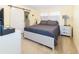 Comfortable bedroom with modern decor and a sliding barn door to the bath at 7714 Sailwinds Pass, Port Richey, FL 34668