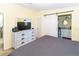 Bedroom with a dresser and sliding barn door leading to the bathroom at 7714 Sailwinds Pass, Port Richey, FL 34668